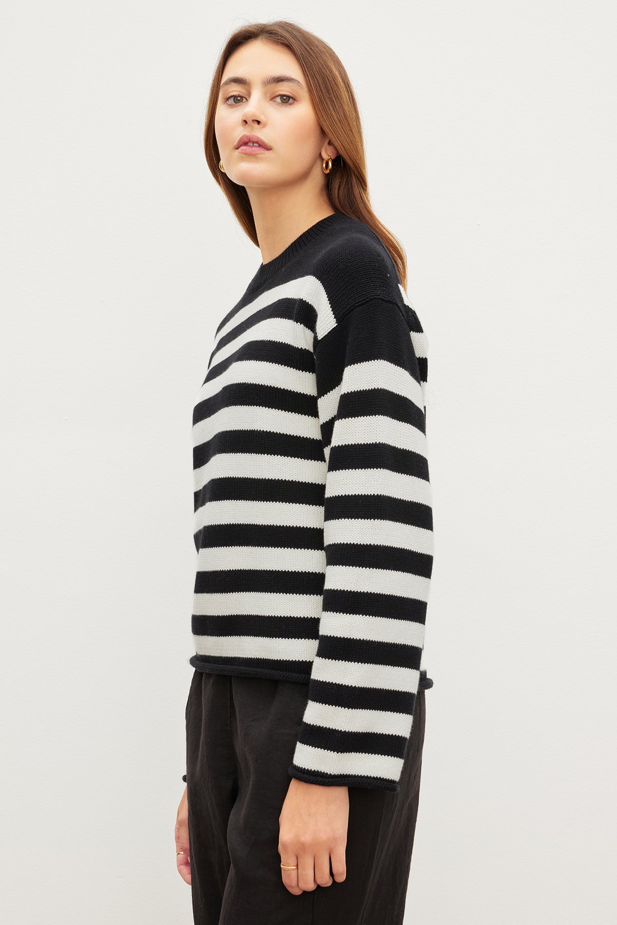 The model is wearing a LEX STRIPED CREW NECK SWEATER by Velvet by Graham & Spencer.-35967621857473