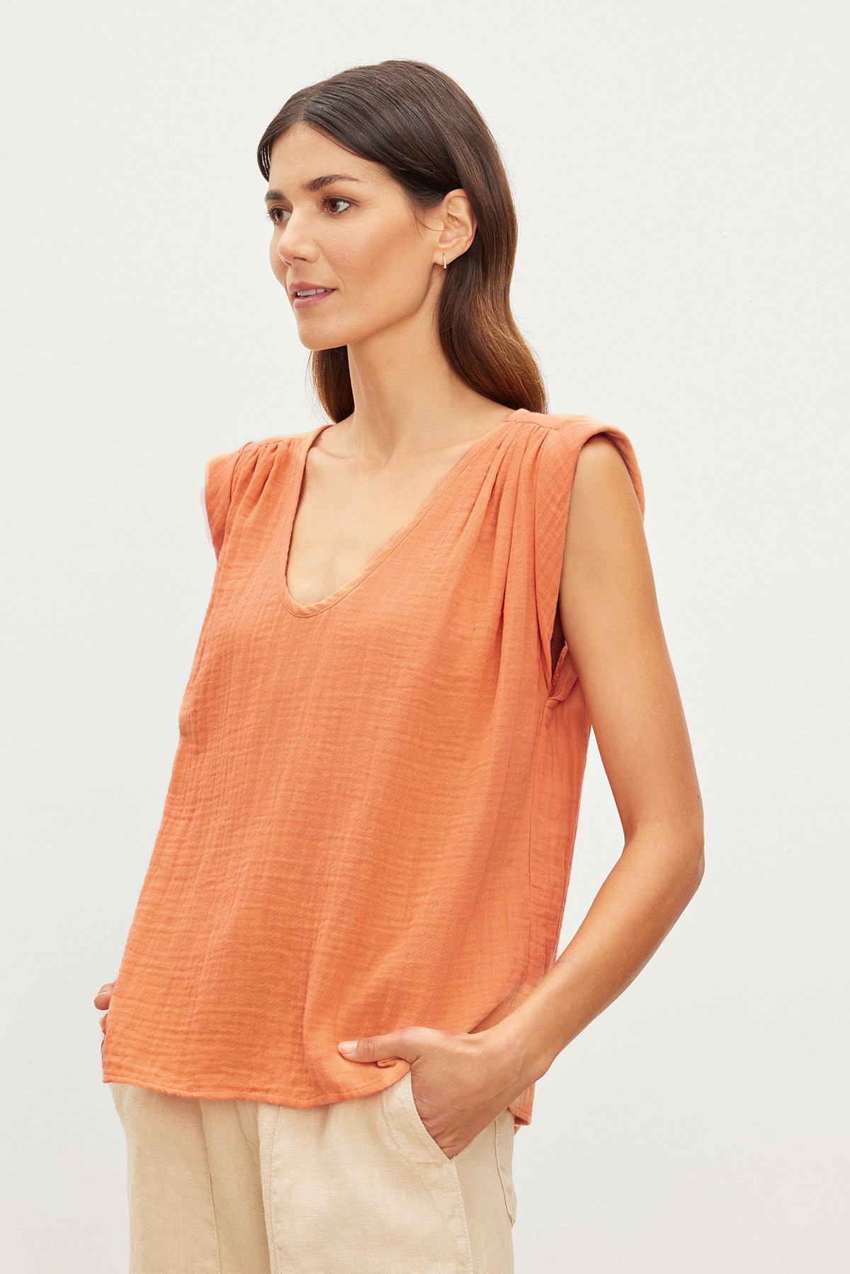   A woman wearing a JAYLA COTTON GAUZE TANK TOP by Velvet by Graham & Spencer with a scoop neck. 