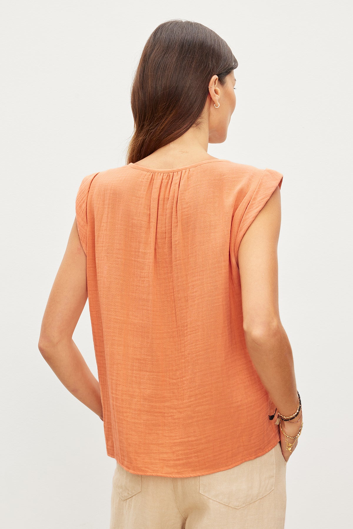   A woman, seen from behind, dons a JAYLA COTTON GAUZE TANK TOP made by Velvet by Graham & Spencer. 