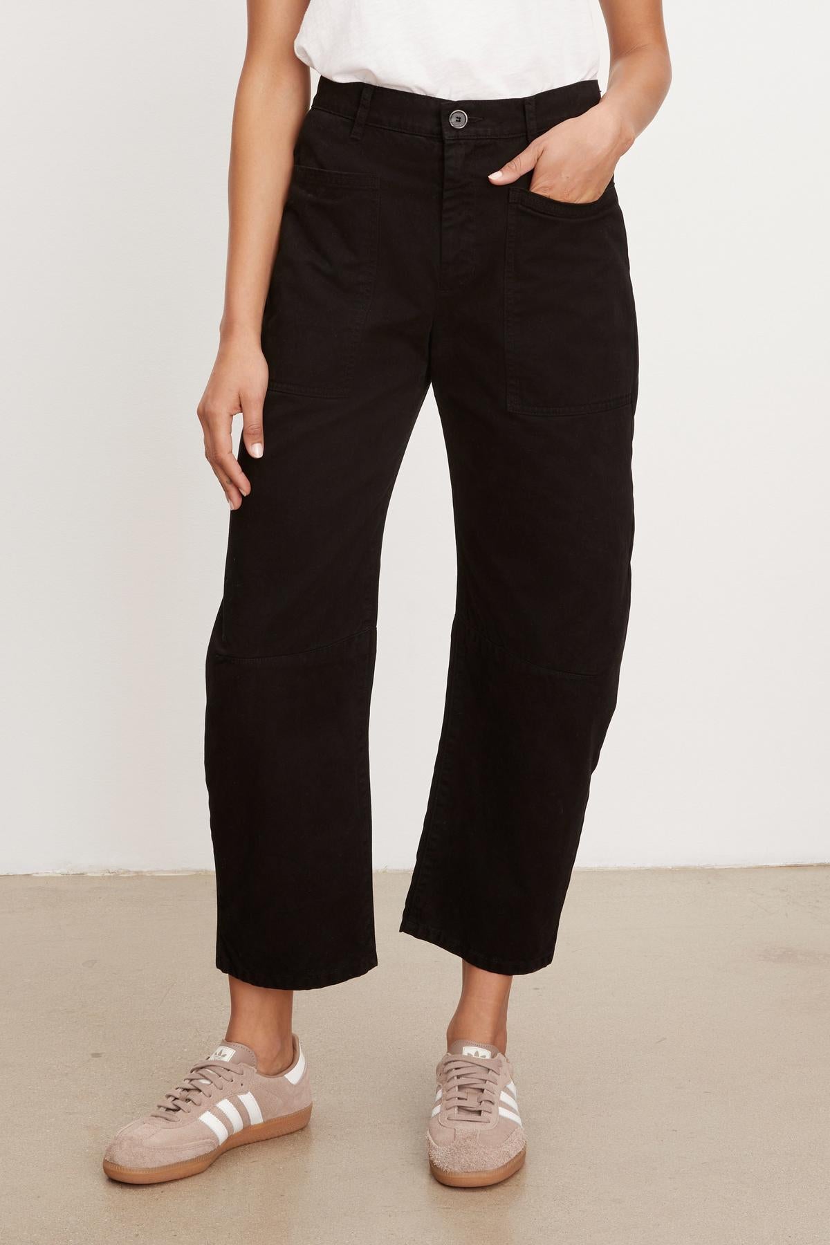 A woman wearing Velvet by Graham & Spencer's BRYLIE SANDED TWILL UTILITY PANT with patch pockets and a white t-shirt.-36040341913793