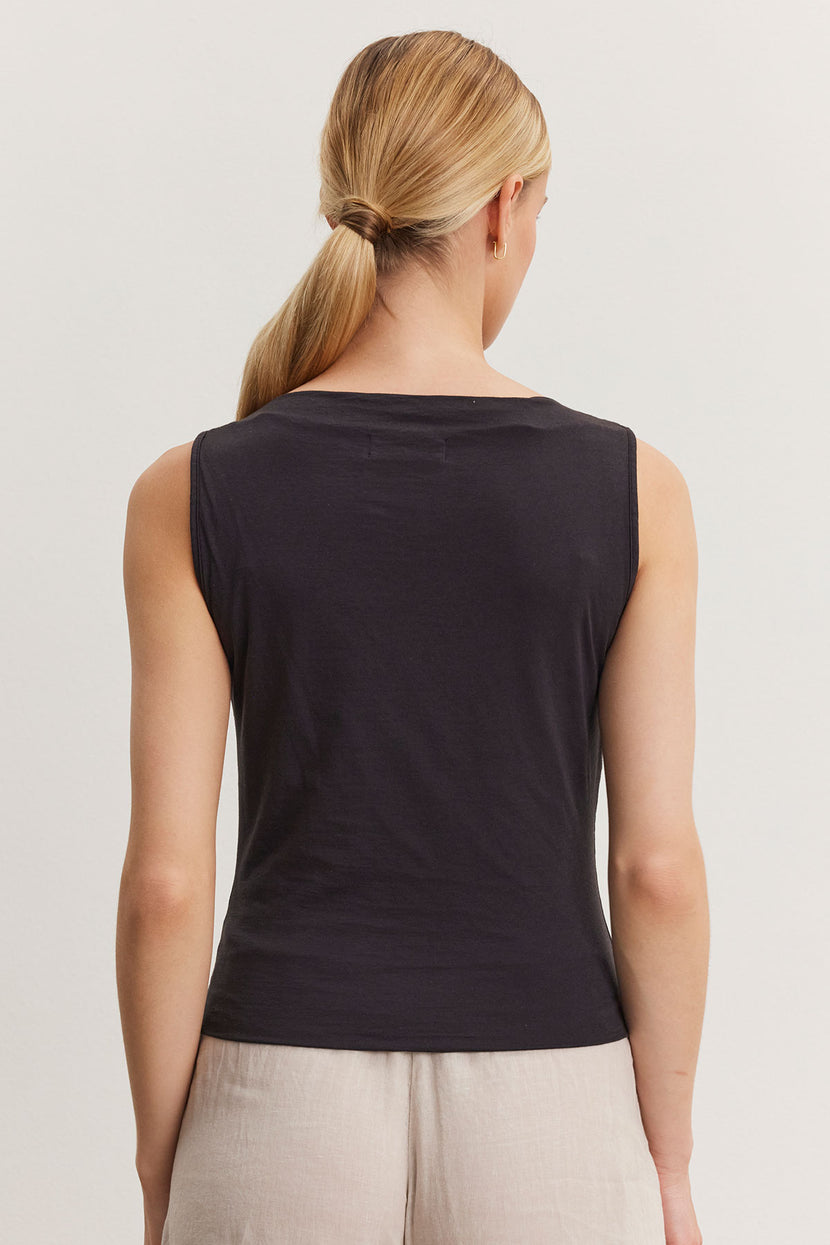 Woman wearing an Emilia tank top by Velvet by Graham & Spencer, viewed from the back, with a ponytail hairstyle.