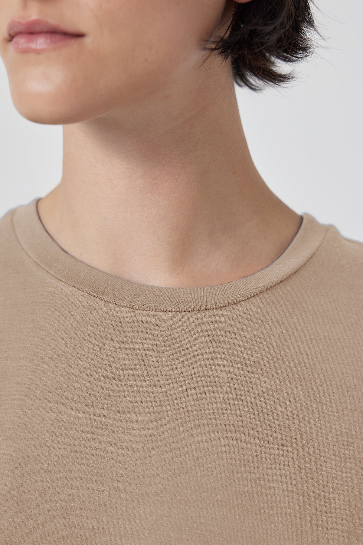 Close-up of a person wearing a Velvet by Jenny Graham Solana Tee, focusing on the neckline and shoulder area.-36290532376769
