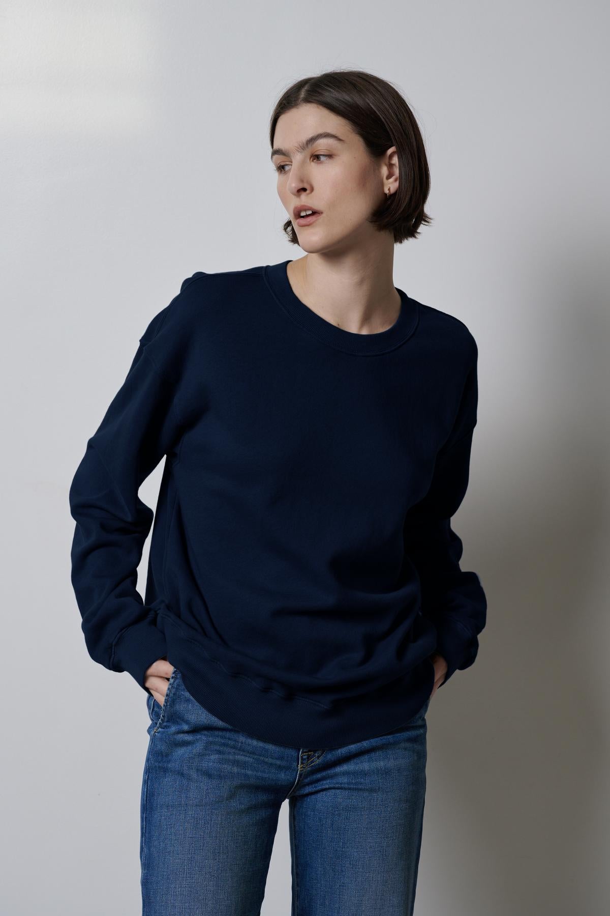 The model is wearing a Velvet by Jenny Graham Abbot sweatshirt, highlighting its styling versatility.-35495979450561