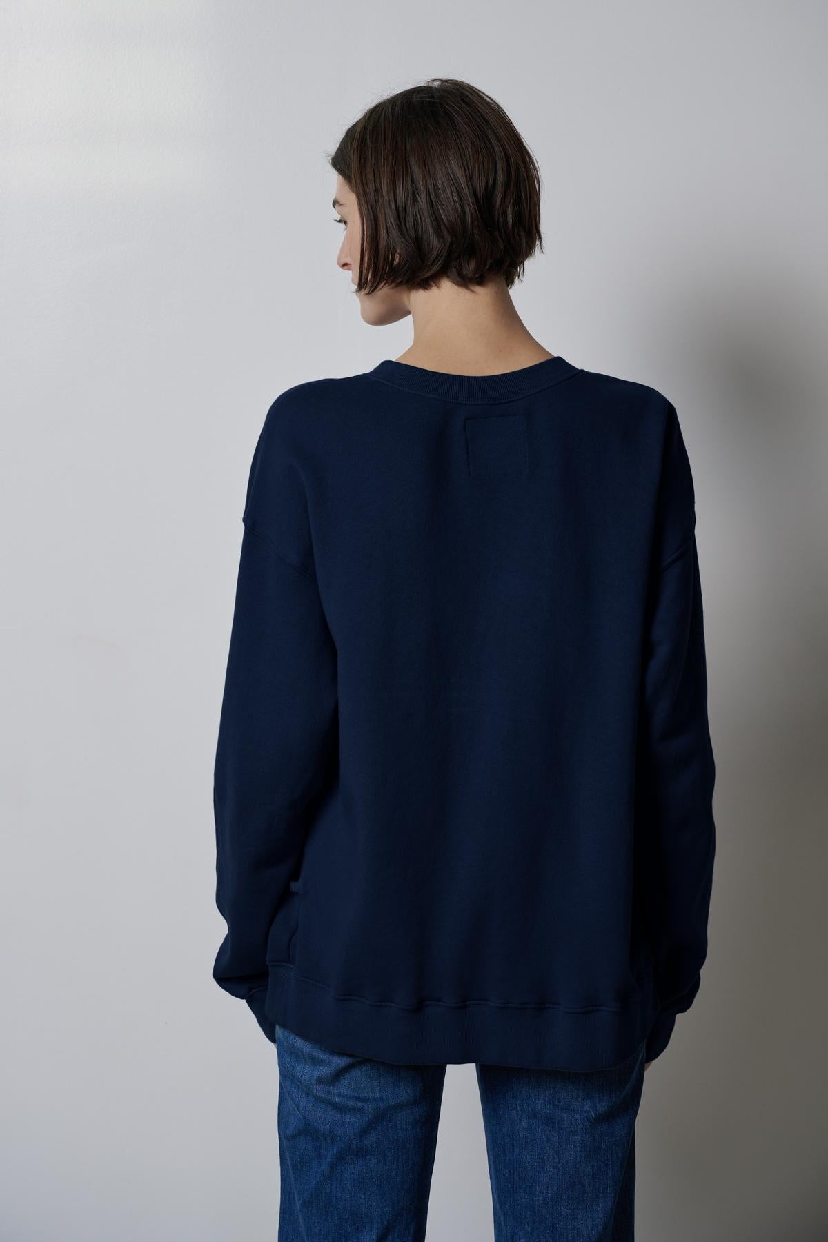 The slouchy back view of a woman wearing a Velvet by Jenny Graham ABBOT SWEATSHIRT made from organic cotton.-35495979548865