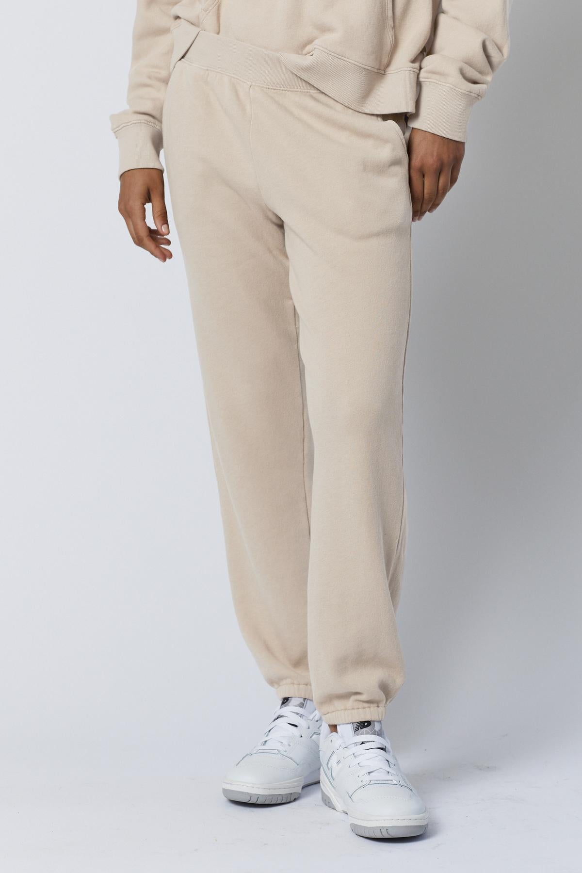 Person wearing Velvet by Jenny Graham's ZUMA SWEATPANT joggers and a matching hoodie with white sneakers, standing against a plain background. Only the lower half of the body is shown.-36863305318593