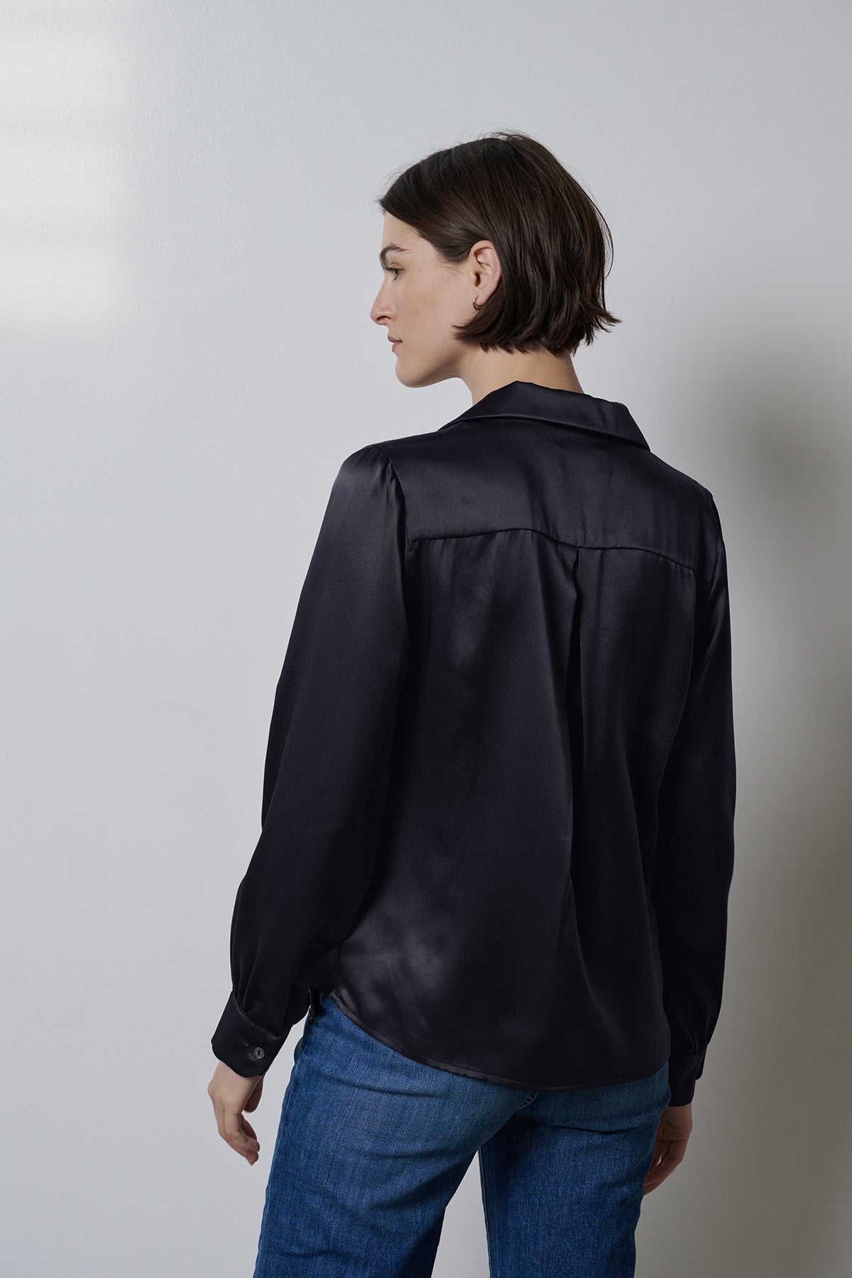 The back view of a timeless woman wearing a Velvet by Jenny Graham SOHO TOP blouse.-35547448967361