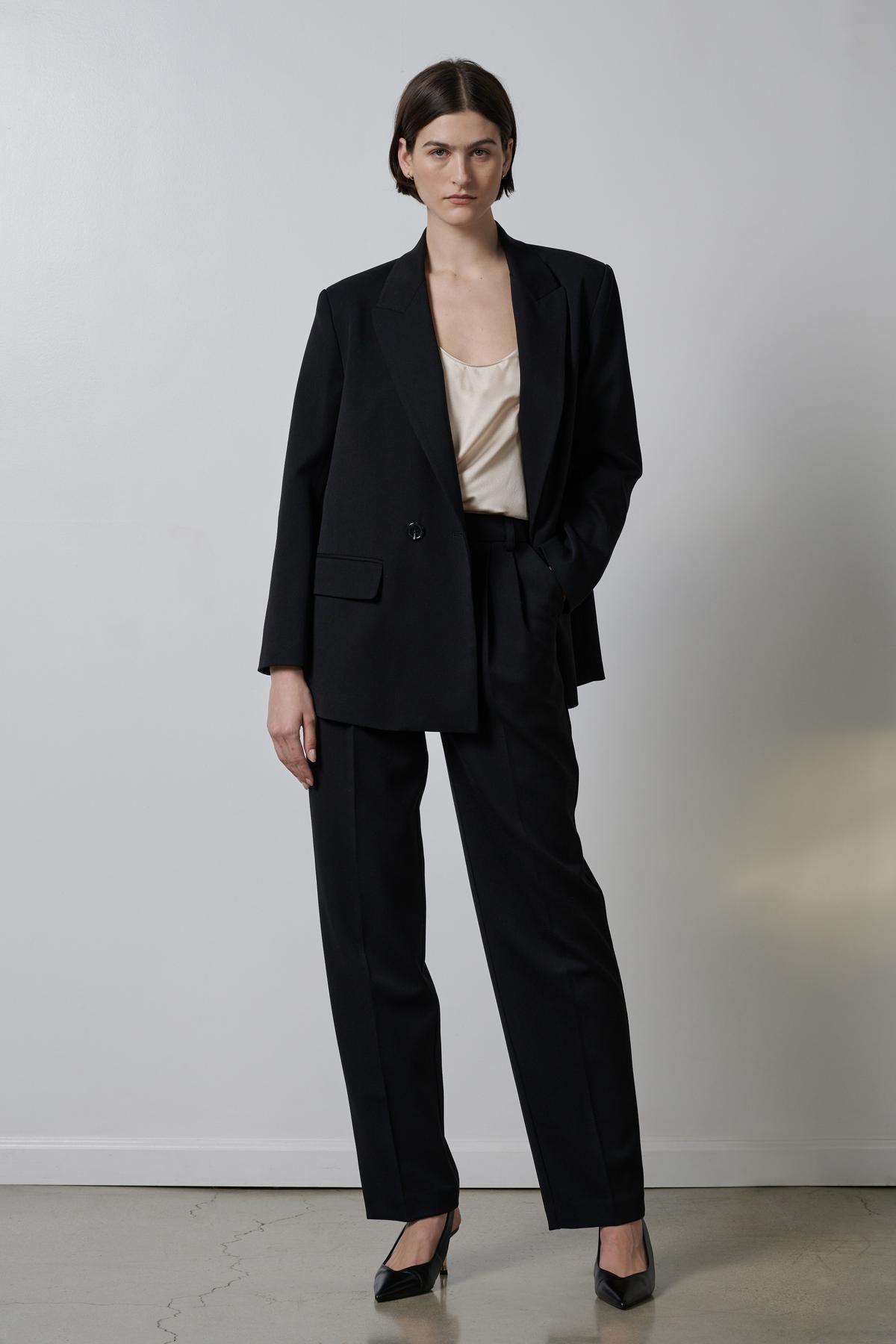 Woman wearing a Velvet by Jenny Graham FAIRFAX blazer and silk blouse, with structured shoulders.-35995793850561