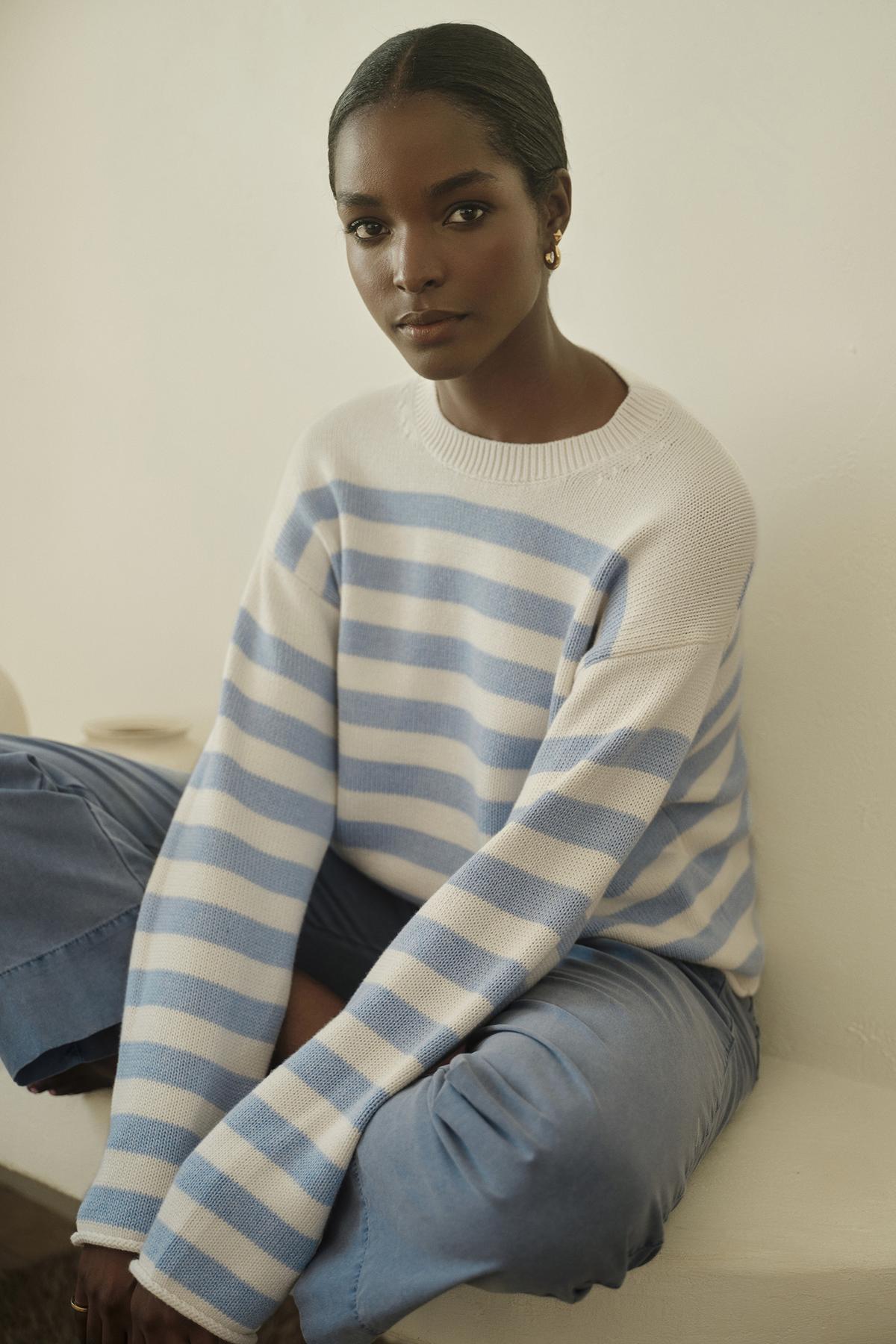   A modern woman wearing a LEX STRIPED CREW NECK SWEATER by Velvet by Graham & Spencer. 
