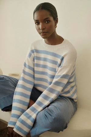 A modern woman wearing a LEX STRIPED CREW NECK SWEATER by Velvet by Graham & Spencer.