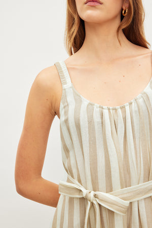 Close-up of a woman in a MERADITH STRIPED LINEN MAXI DRESS by Velvet by Graham & Spencer, focusing on the upper body and detailing of the fabric.