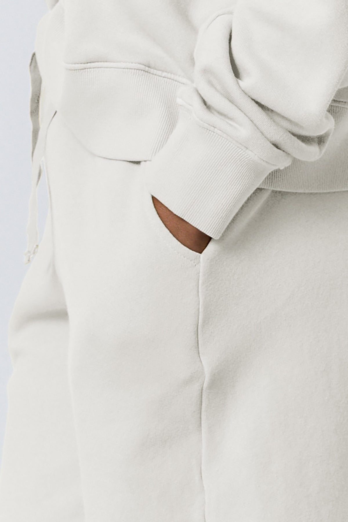 a woman wearing Velvet by Jenny Graham LAGUNA SWEATSHORT sweatpants and a white hoodie.-26019359031489