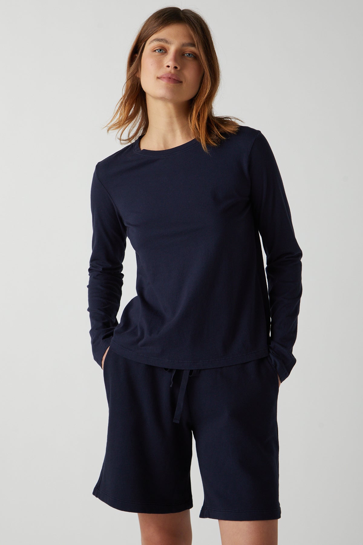 the model is wearing a navy long-sleeved top and Velvet by Jenny Graham LAGUNA SWEATSHORT.-26019334947009