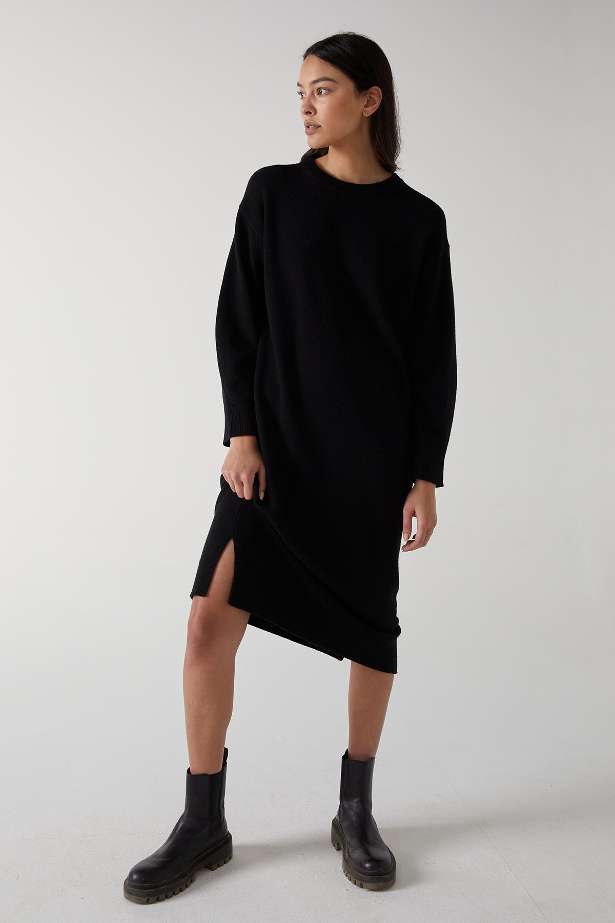 The model is wearing a black LAUREL DRESS by Velvet by Jenny Graham with side hem slits.-25315829612737