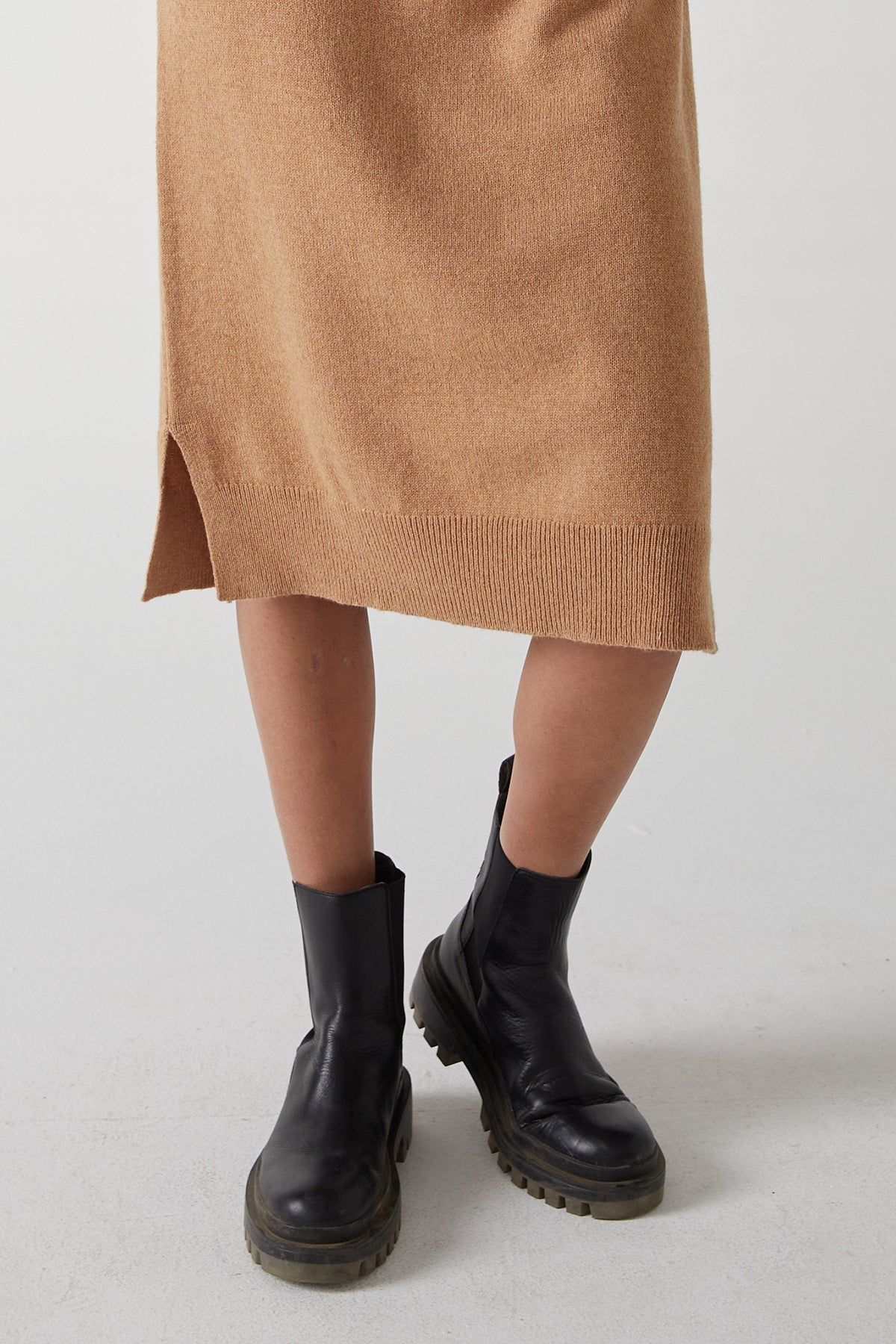 A woman wearing a Velvet by Jenny Graham Laurel Dress with side hem slits and black boots.-25315843801281