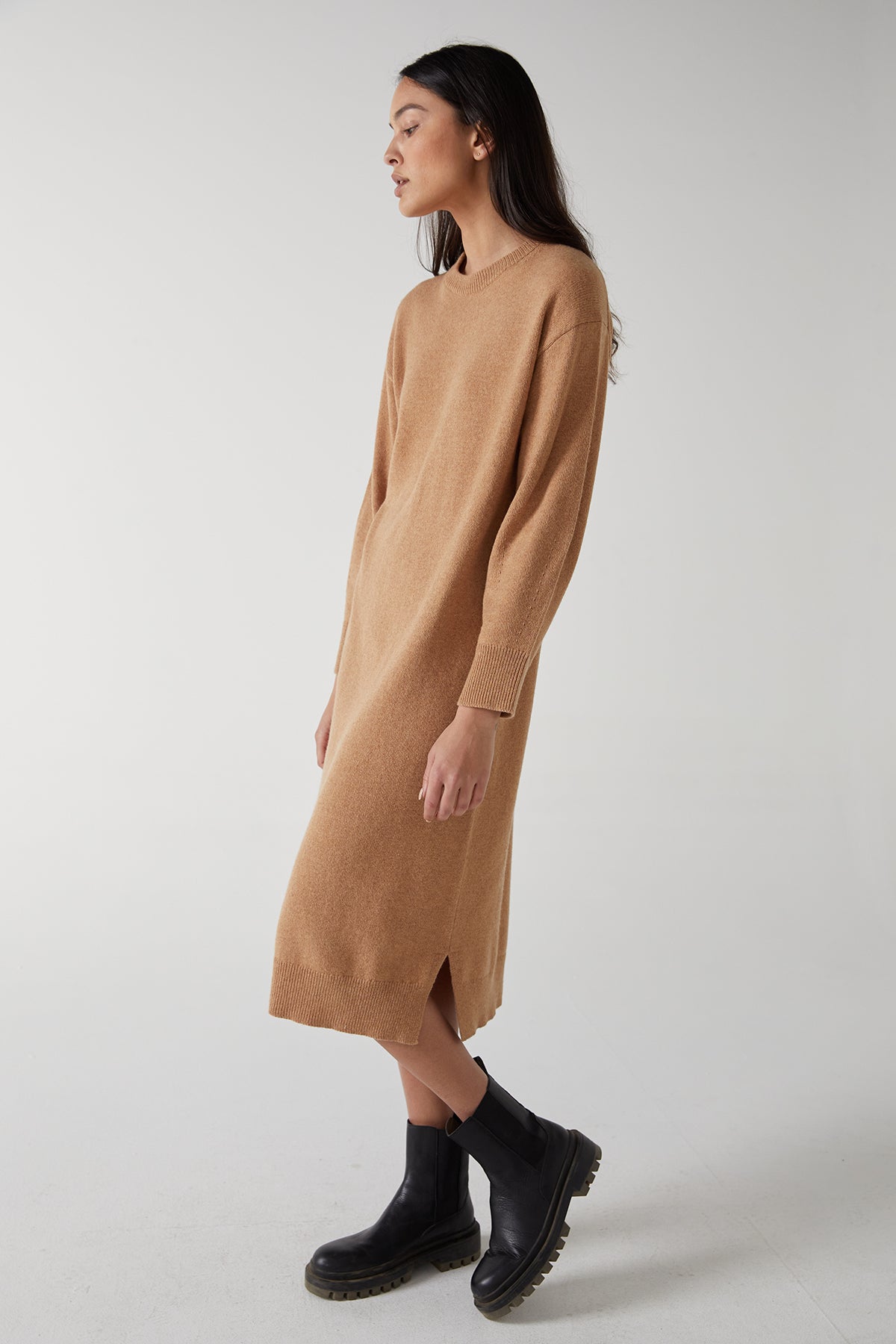 The model is wearing a Velvet by Jenny Graham LAUREL DRESS with side hem slits.-25315843899585